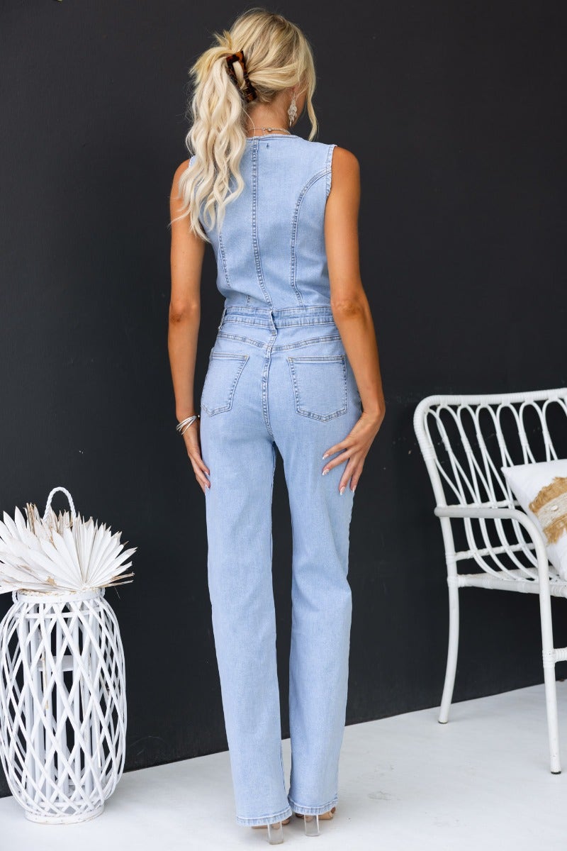 Back view of a woman in a Kentwell denim jumpsuit with pockets, showcasing a slightly relaxed fit.
