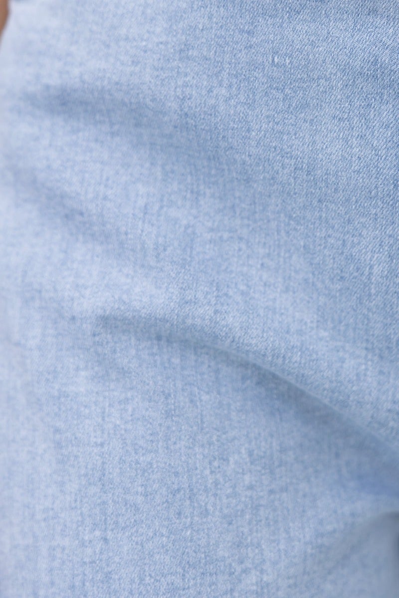 Close-up view of soft blue denim fabric, showcasing texture and stretch of the Kentwell Denim Jumpsuit.
