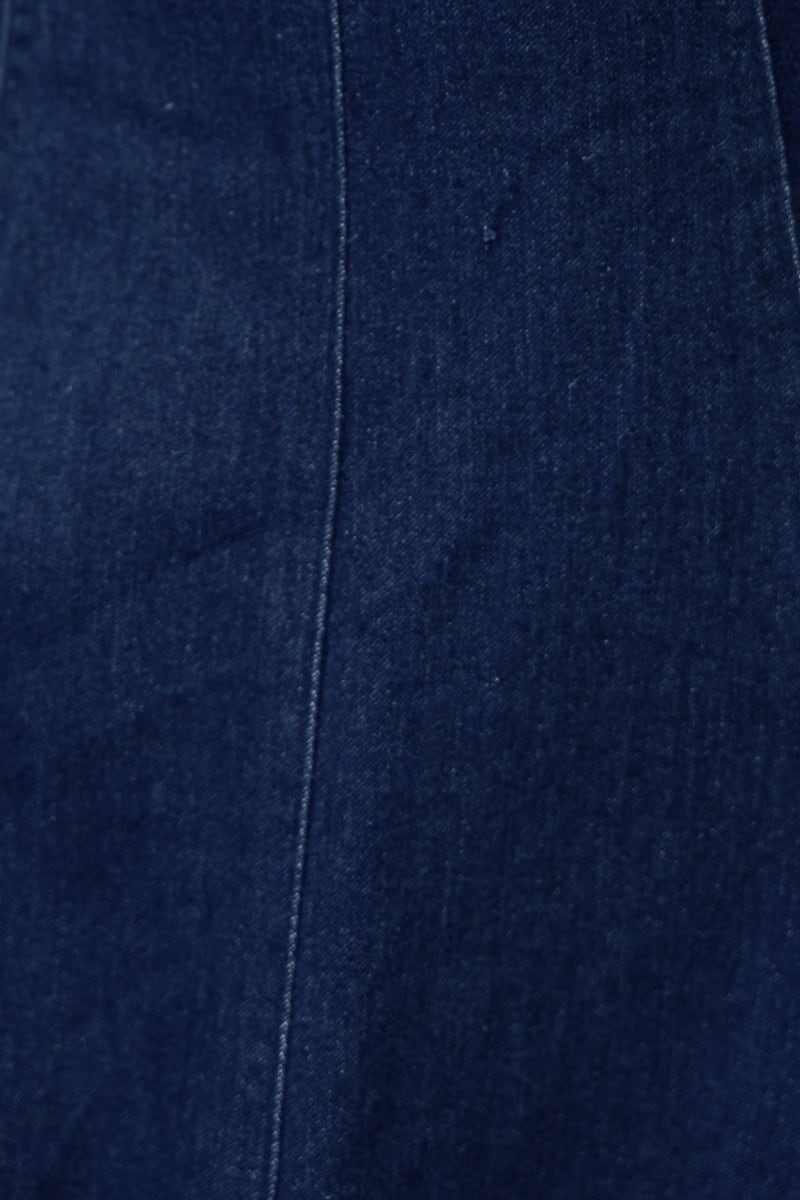 Close-up of dark navy denim fabric featuring a smooth texture and detailed stitching, ideal for a stylish midi dress.