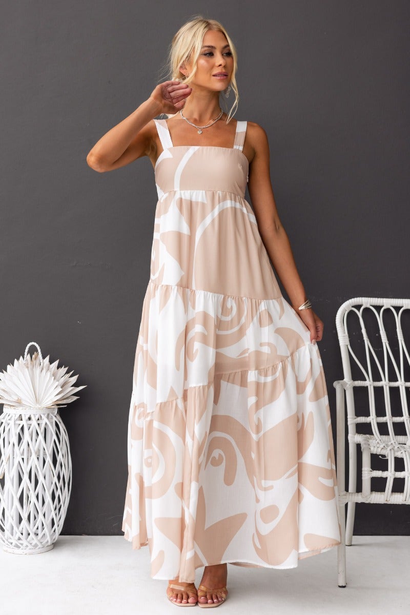 Franco Maxi Dress in a soft beige and white pattern, featuring adjustable straps and a flowing silhouette.