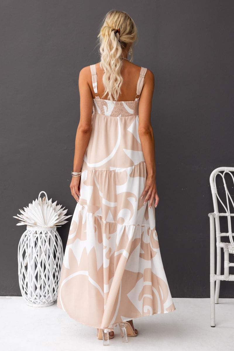 Back view of a Franco maxi dress in a floral pattern, featuring adjustable straps and a flowy silhouette.