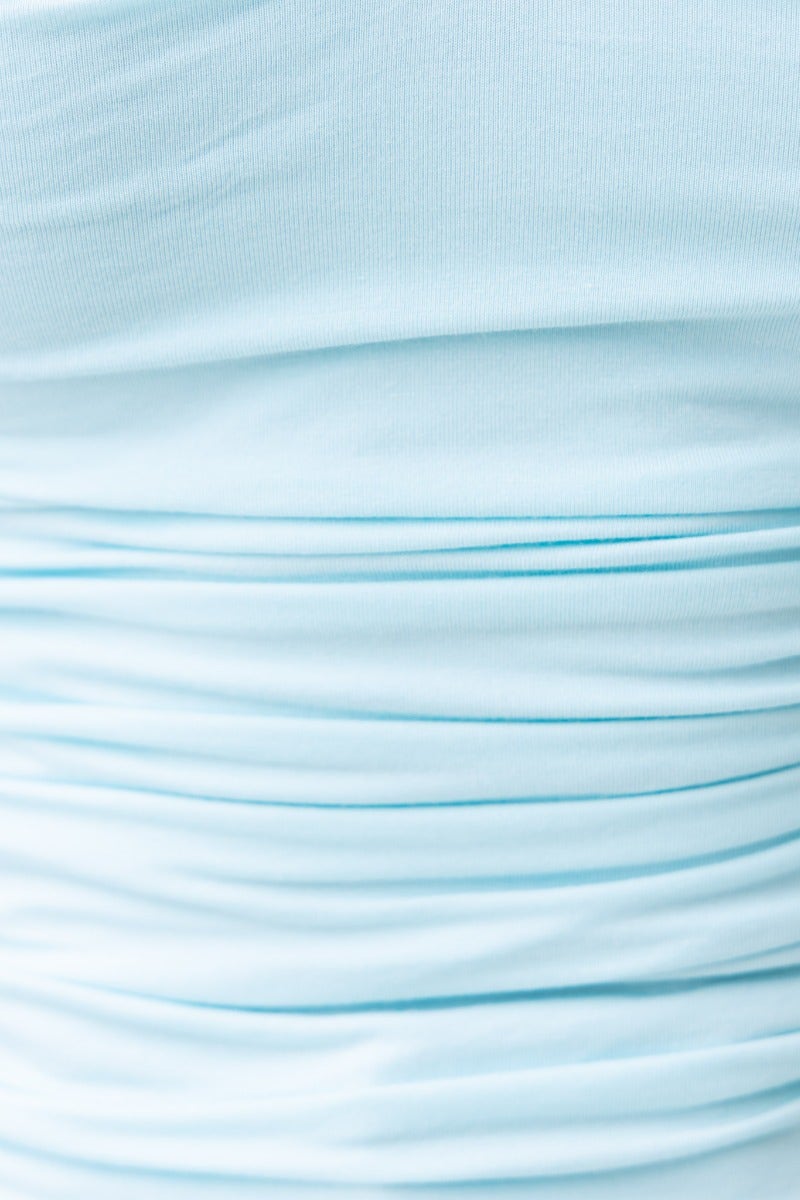 Close-up of light blue cotton blend fabric showing ruching details for Kodey Top.