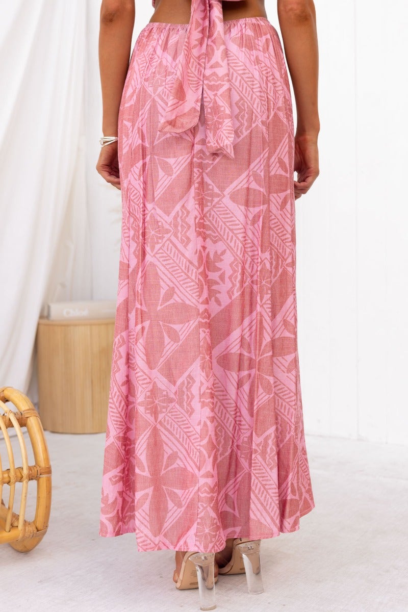 Back view of a pink patterned Kona Maxi Skirt with a tie waist detail, perfect for summer outings.