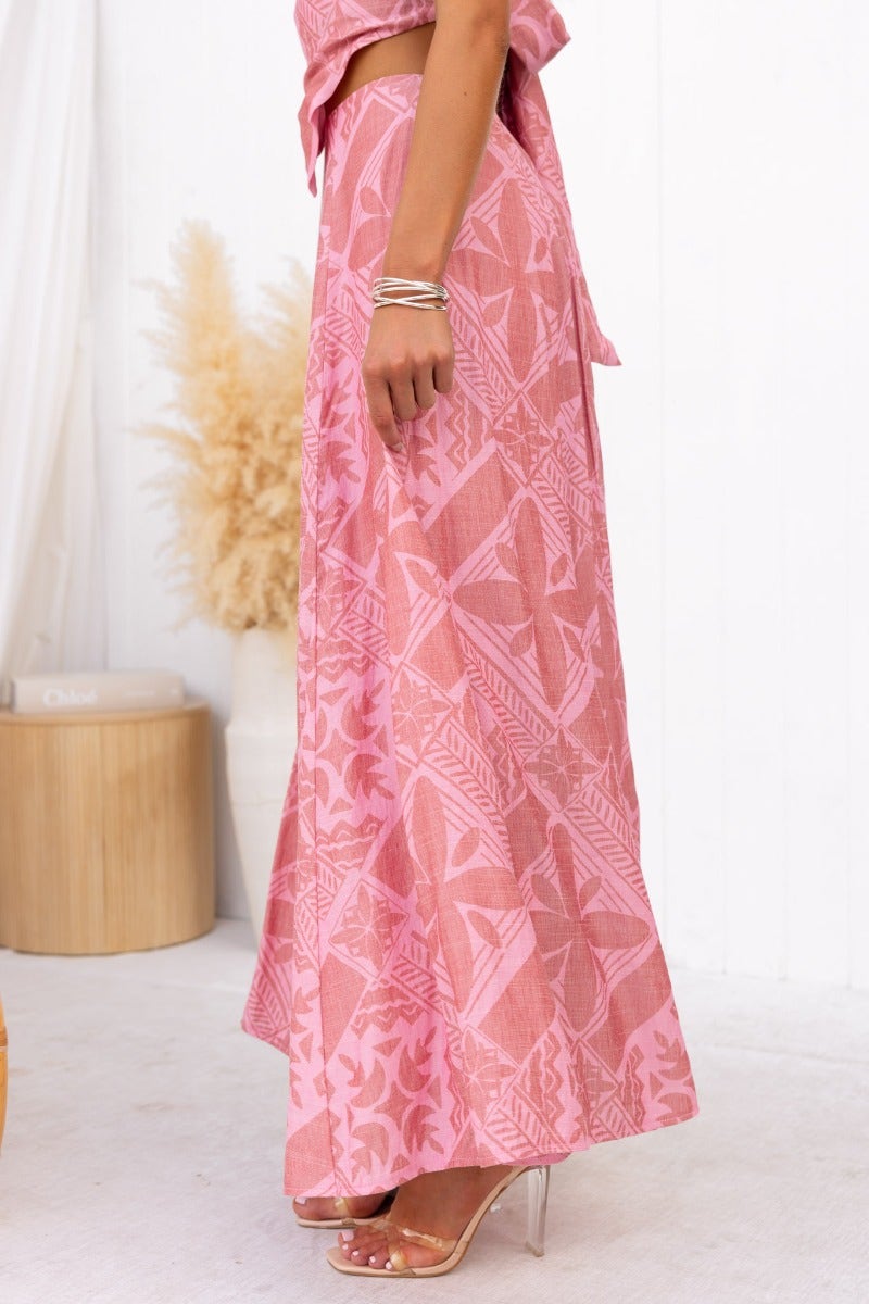 Kona Maxi Skirt in pink with floral patterns, mid-high waist, shown in a side view on model.