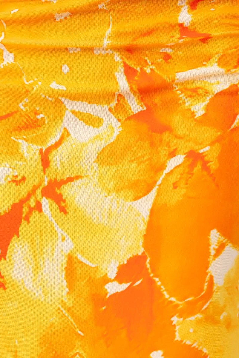 Vibrant yellow fabric with abstract orange patterns, ideal for summer fashion and dresses.