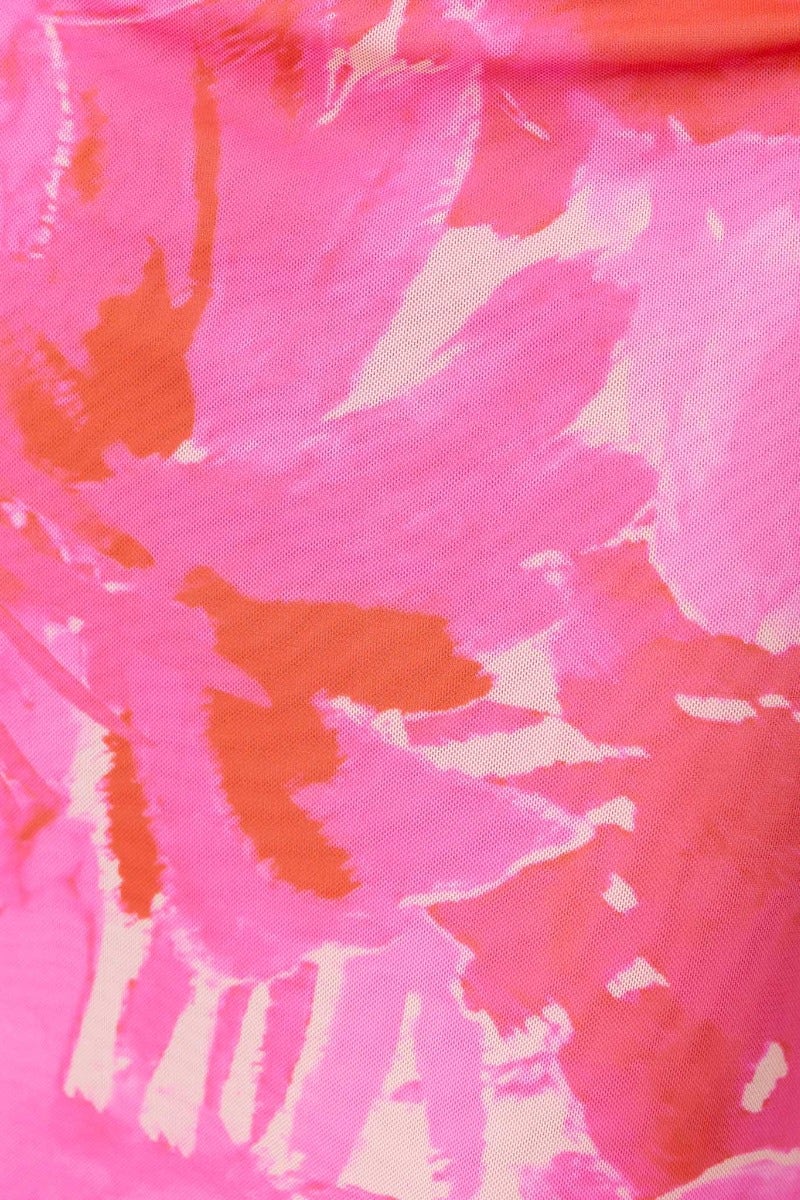 Bright pink floral pattern fabric with orange accents, showcasing a vibrant design for a maxi dress.