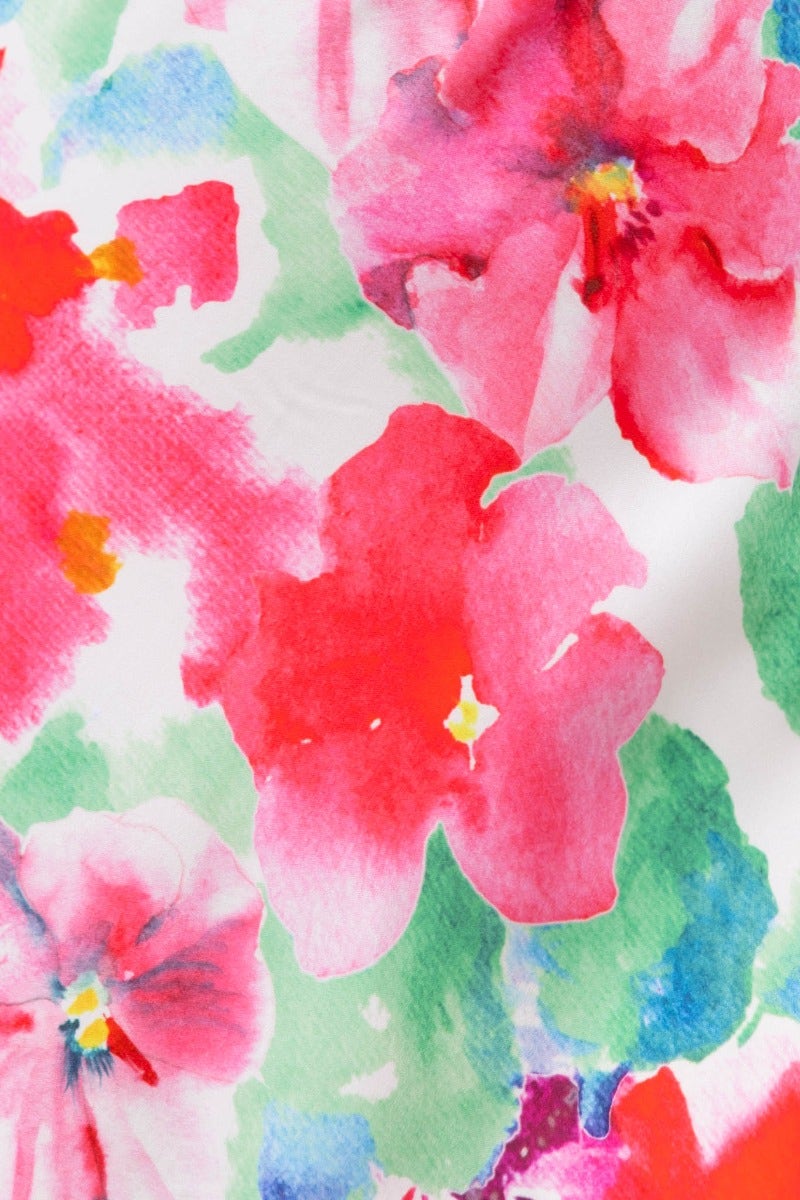 Vibrant floral print featuring pink and red flowers with green accents, perfect for enhancing a feminine maxi dress.