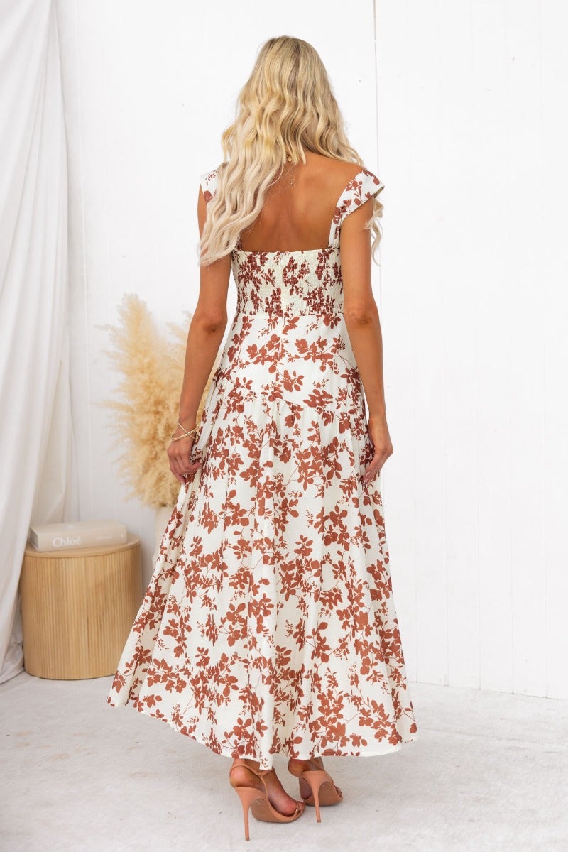 Back view of Heartbreak Maxi Dress featuring floral print and ruffle sleeves, perfect for summer occasions.