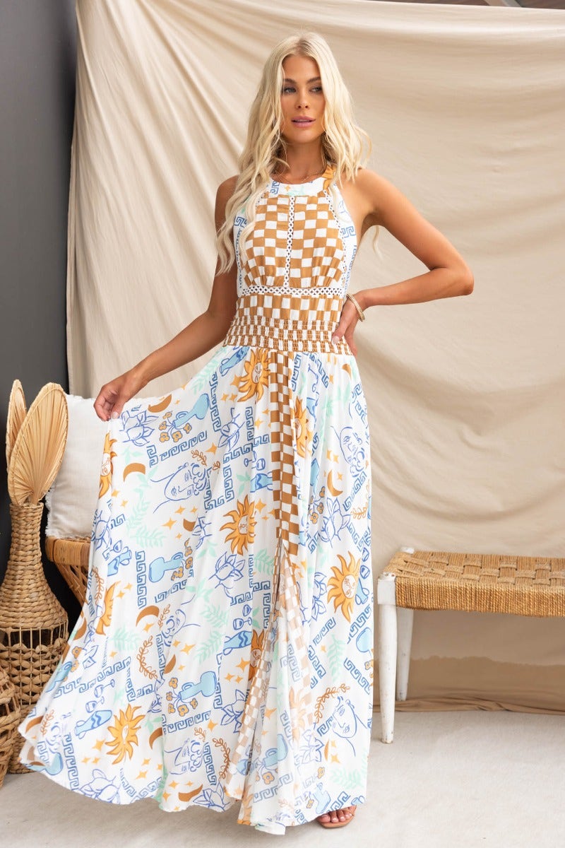 Model wearing Relly Maxi Dress featuring an abstract print, high halter neckline, and front split.
