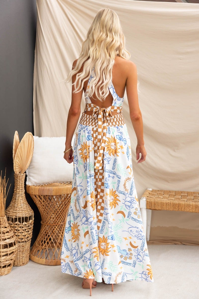 Back view of the Relly Maxi Dress, featuring an abstract print, halter neckline, and elastic waistband.
