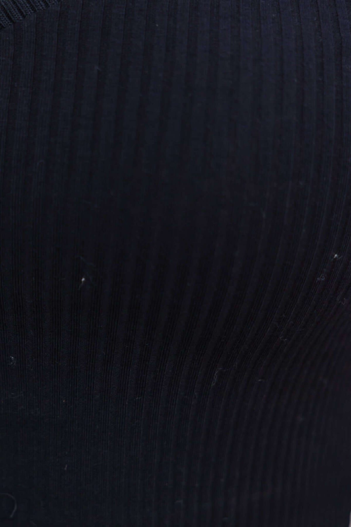 Close-up of black ribbed fabric showcasing stretch material for the Harford Top.