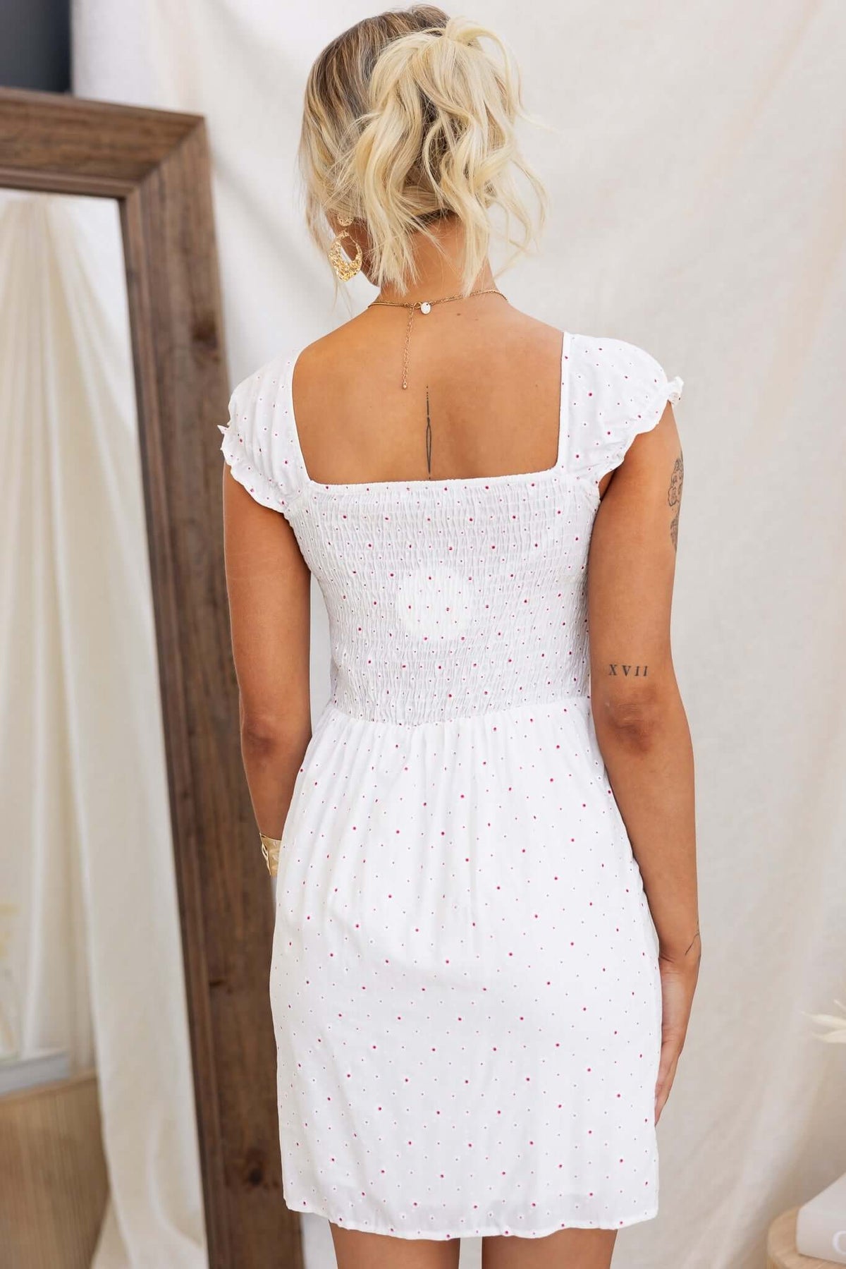 Back view of Rouse Dress featuring tie at bust, elastic back, and a sweet floral pattern.