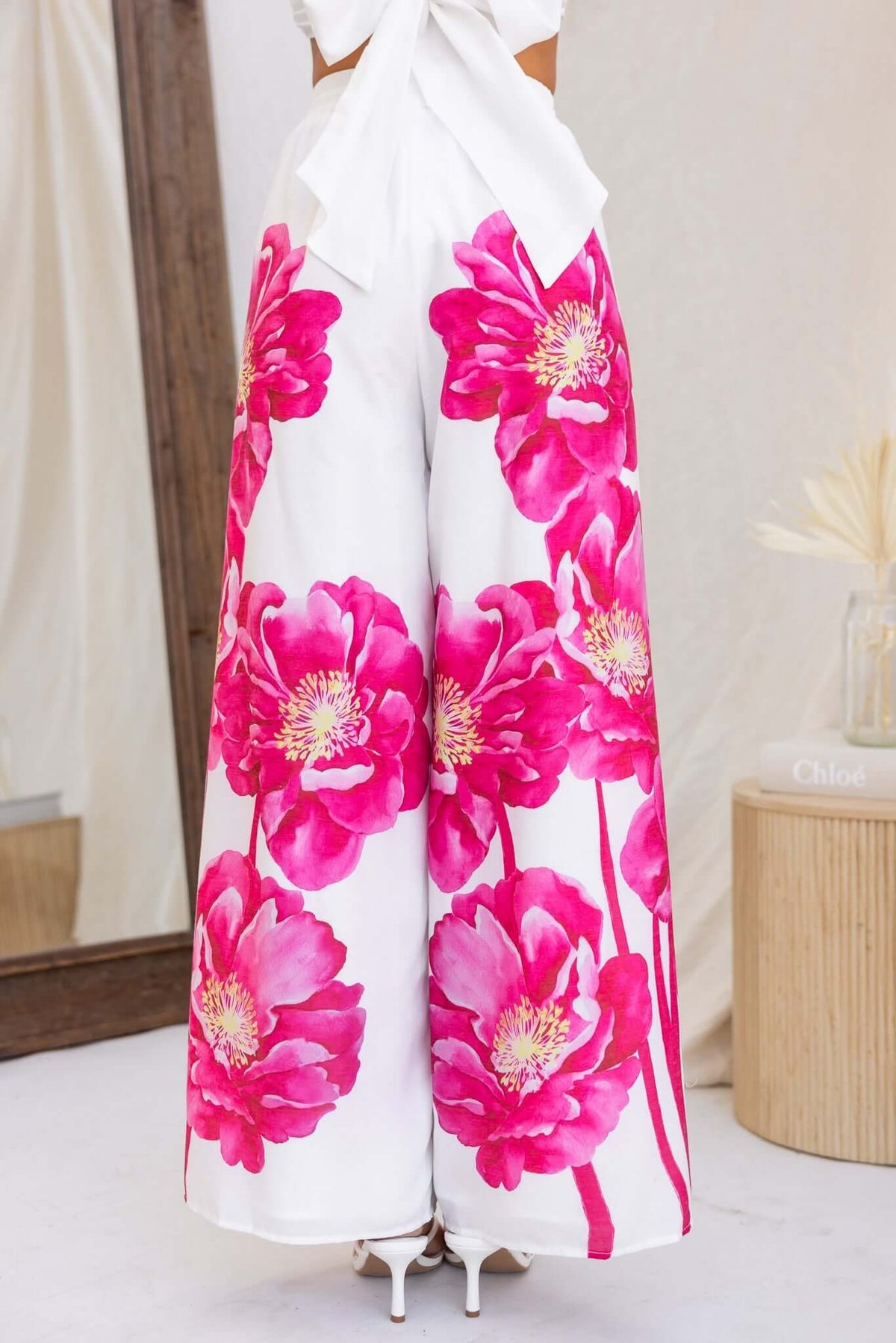 Faly Pants featuring a vibrant floral print with pink peonies on a white background, showcasing a stylish mid-high waist design.