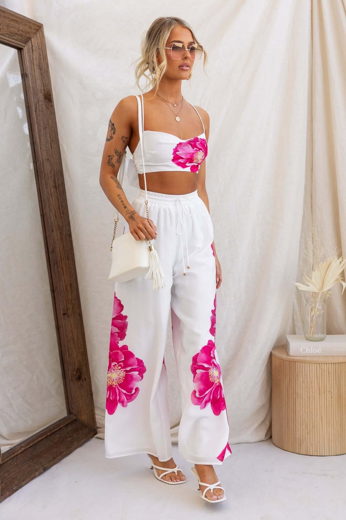 Model wearing Faly Pants with a floral design, mid-high waist fit, and lightweight cotton material.