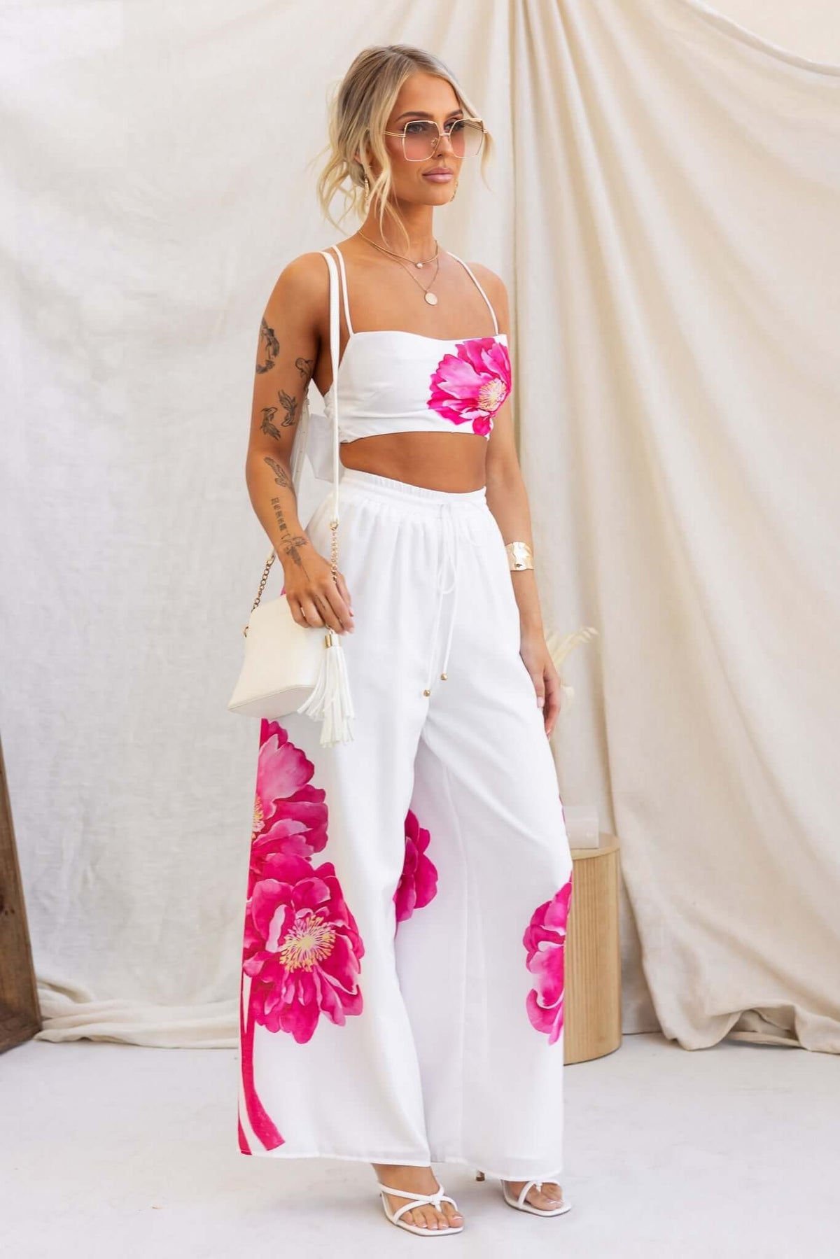 Faly Pants styled with floral white top, featuring mid-high waist, elastic waistband, and lightweight cotton for a relaxed look.