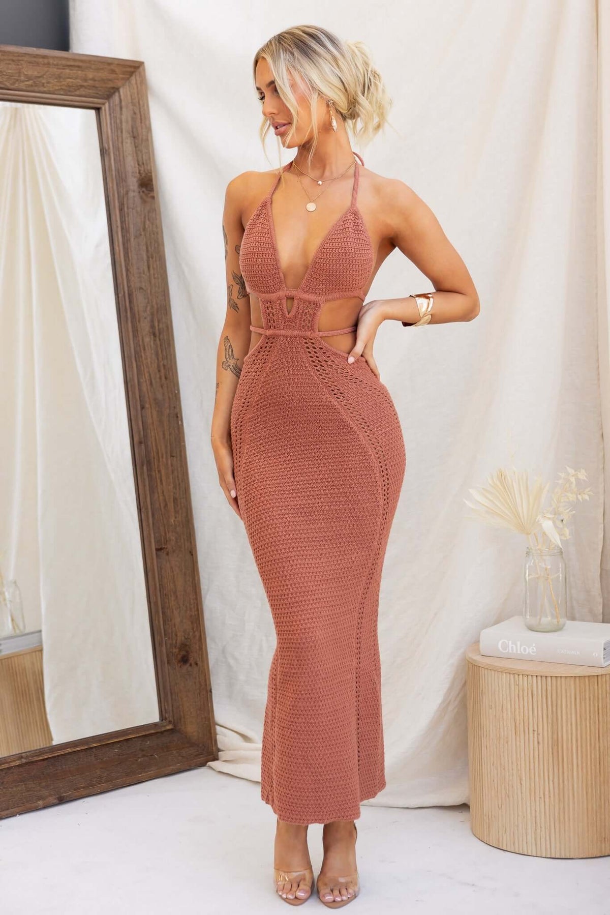 Model wearing a Hold Up Maxi Dress in dusty rose, featuring crochet design, adjustable neckline, and cut-out waist detail.