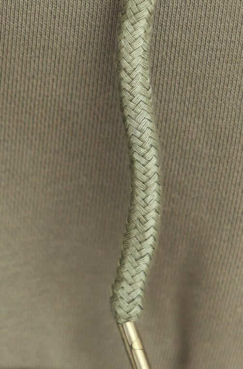Close-up of the drawstring on a Ross Jumper, showcasing the braided texture and olive green fabric.
