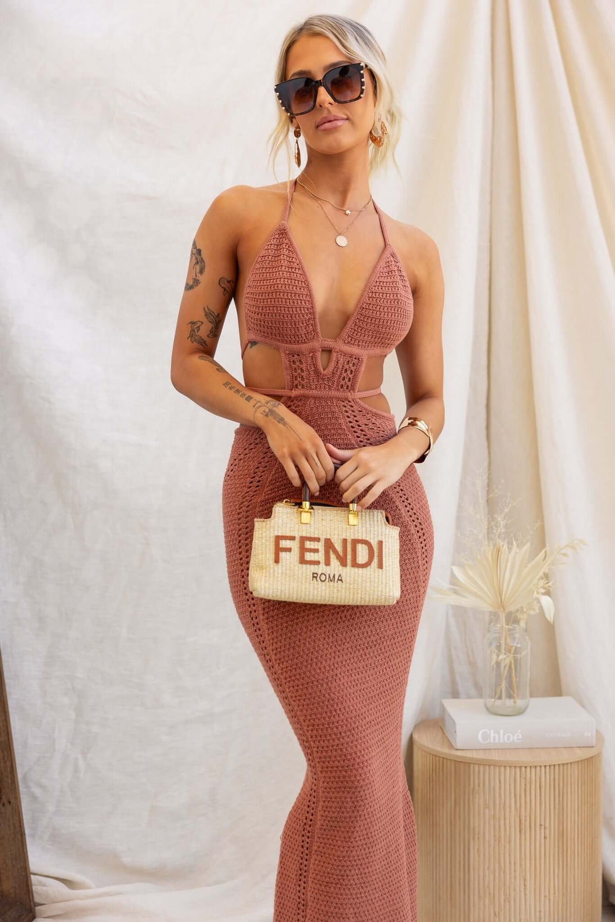 Model wearing Hold Up Maxi Dress featuring crochet design, adjustable tie neckline, and cut-out waist with tie detail.