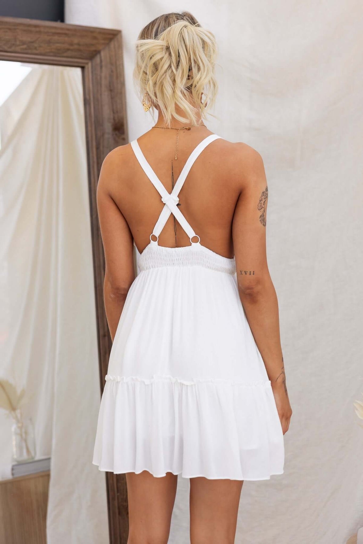 Back view of the Lisle Dress showing adjustable straps and elastic waistband, styled for summer fashion.