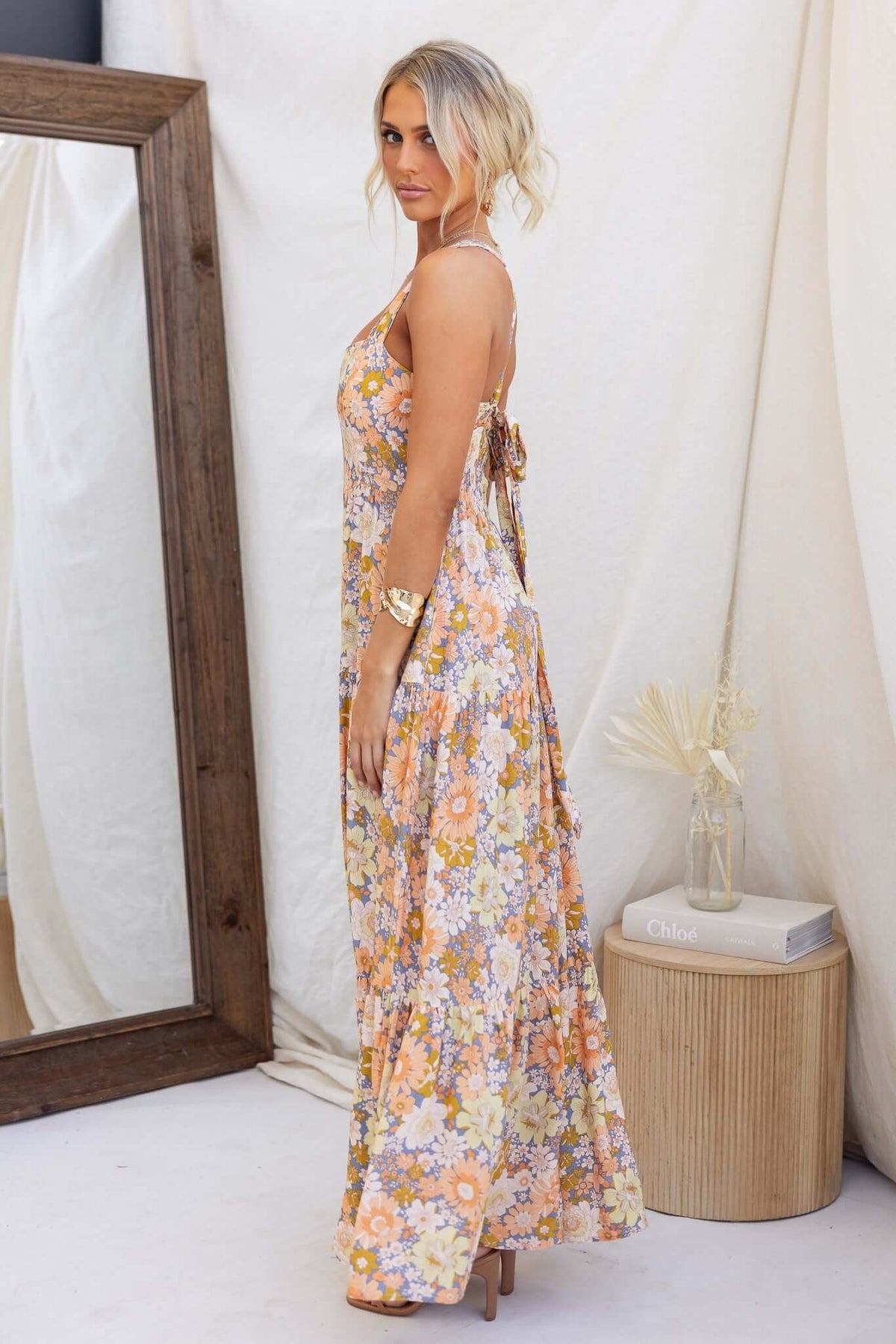 Etsie Maxi Dress in floral print, featuring adjustable halter neckline and side pockets, styled casually.