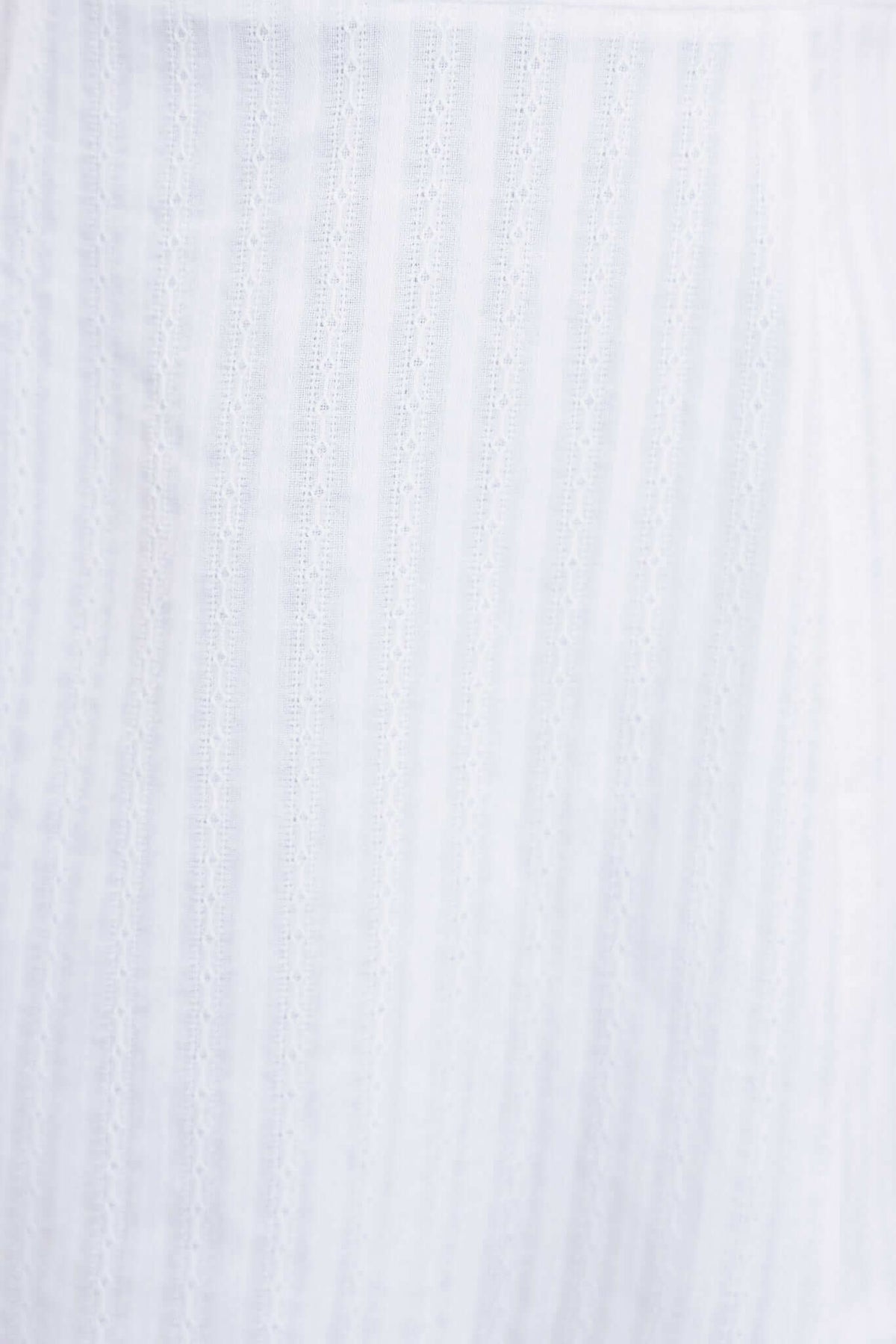 Soft white cotton fabric with subtle stripes, perfect for the Calyssa Dress, showcasing elegant texture and quality.