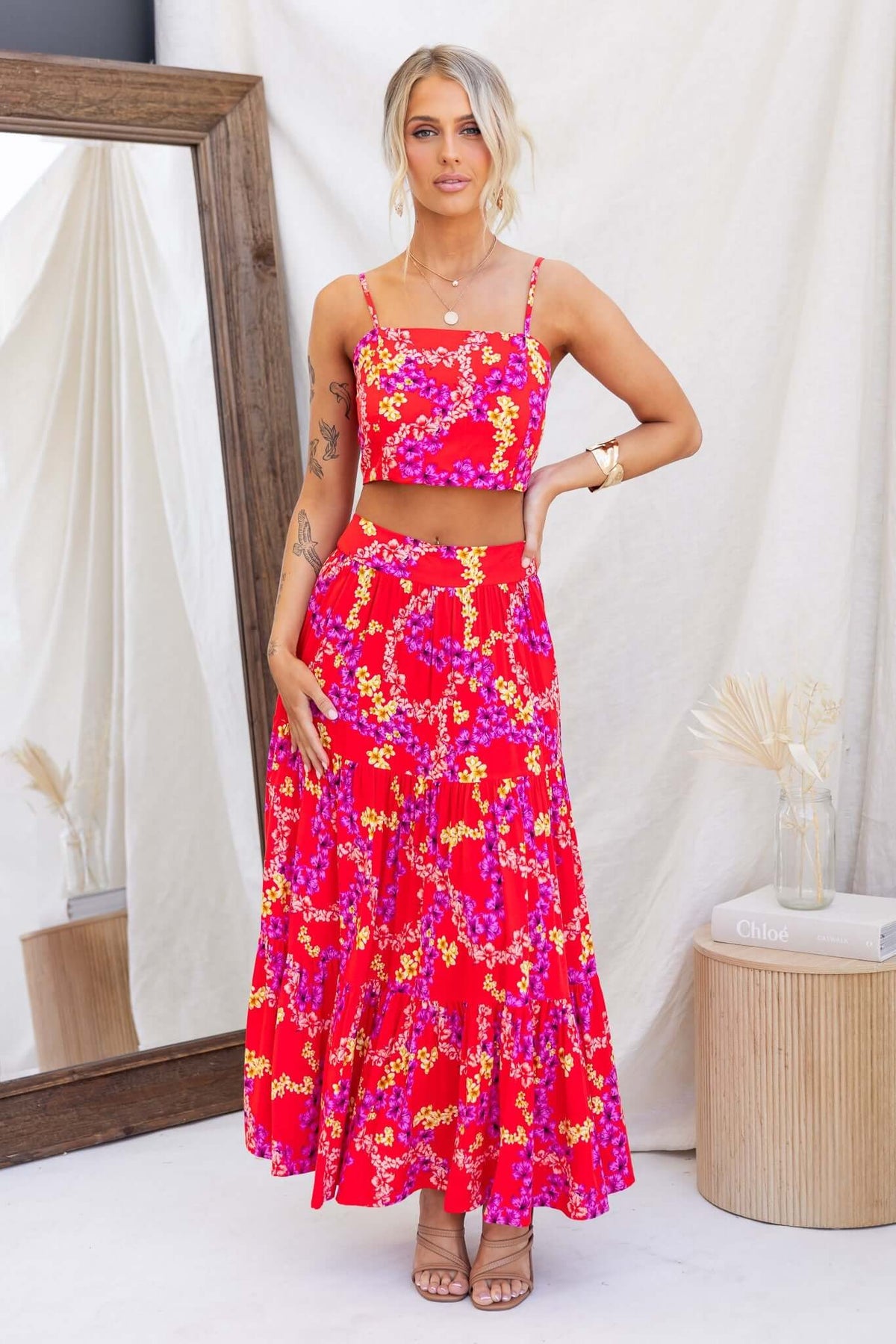Hadid Maxi Skirt featuring a colorful floral design, mid-high waist, with pockets, styled with a matching crop top.