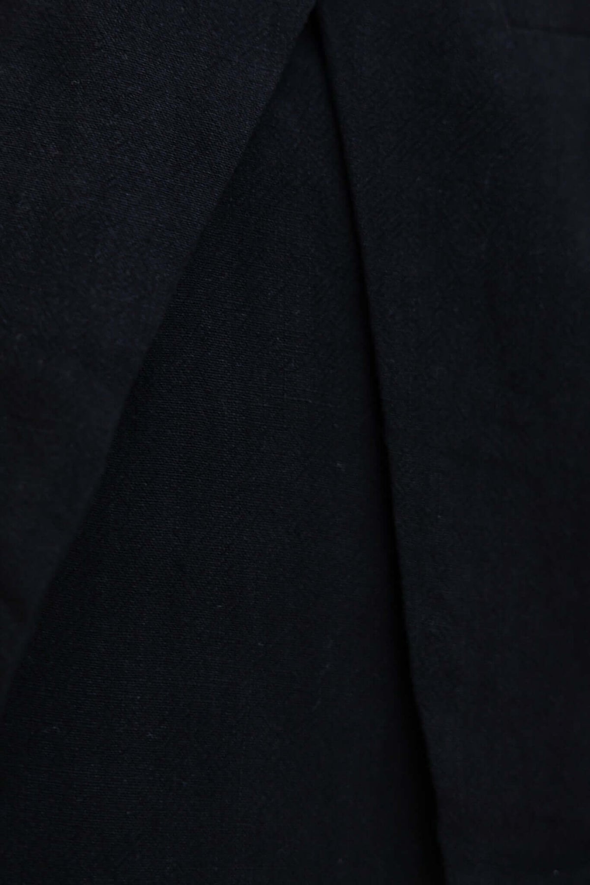 Close-up of the textured black fabric from the Bexley Top, showcasing its linen-like feel and smooth finish.