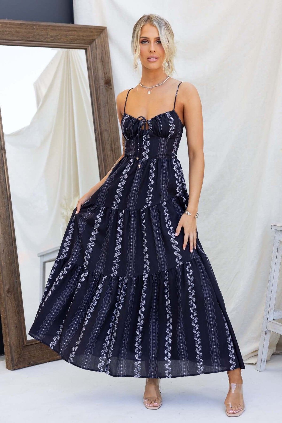 Elegant black Eider maxi dress with adjustable straps and tie detail, perfect for effortless style and comfort.