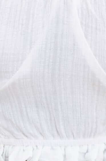 Close-up of the lightweight fabric texture of the Fresno Top, featuring a soft off-shoulder design.