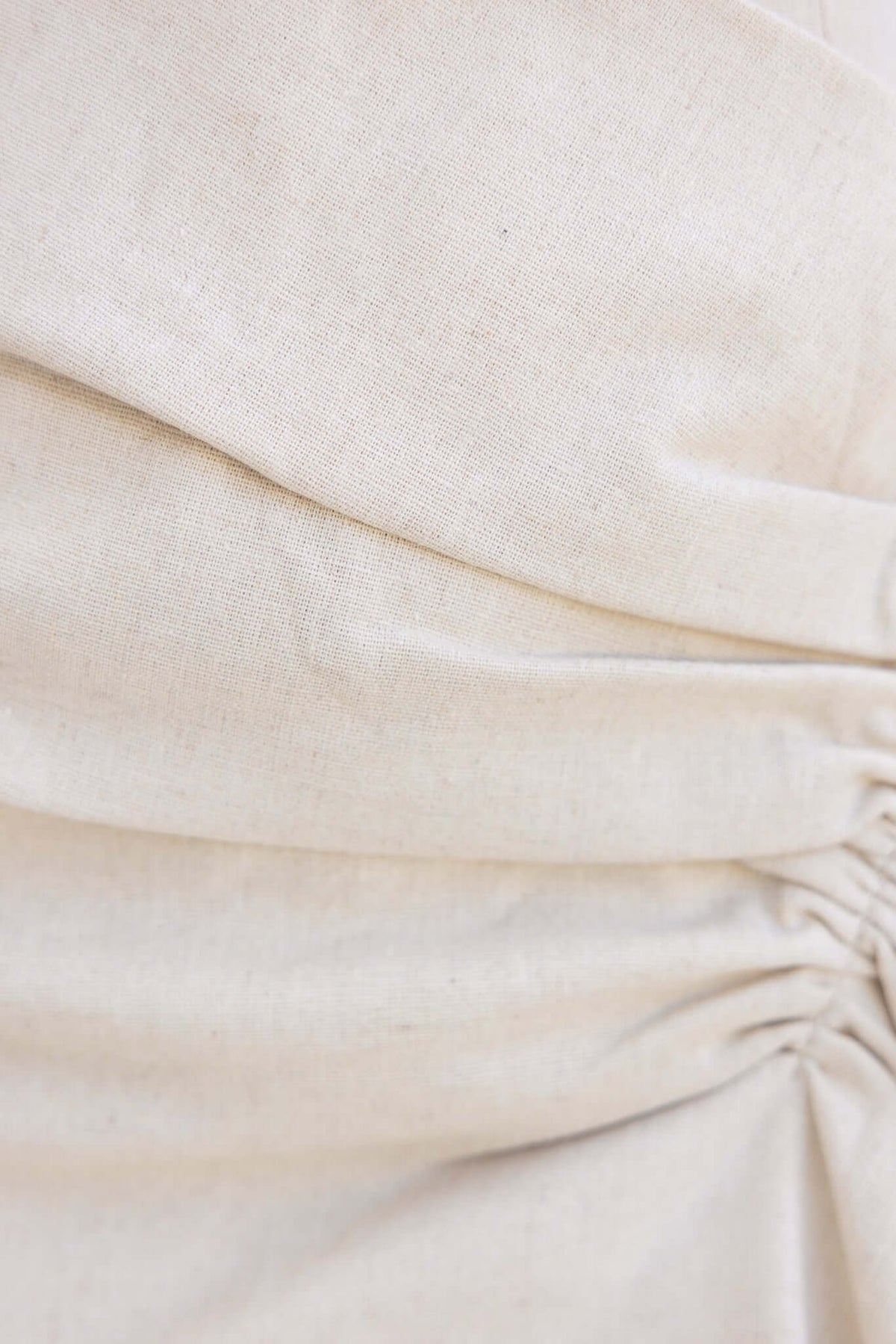 Close-up of textured fabric on a beige Shannon Skirt showcasing the gathered design and soft cotton feel.