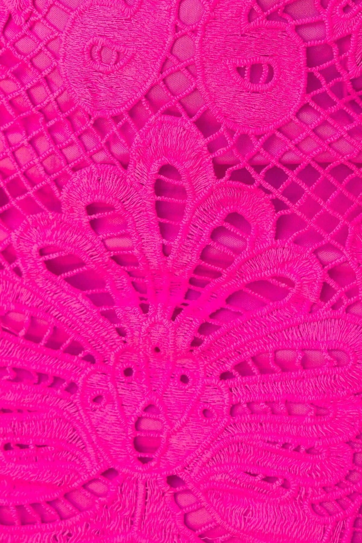 Close-up of vibrant pink lace detailing, showcasing intricate embroidery patterns for a stylish maxi dress.