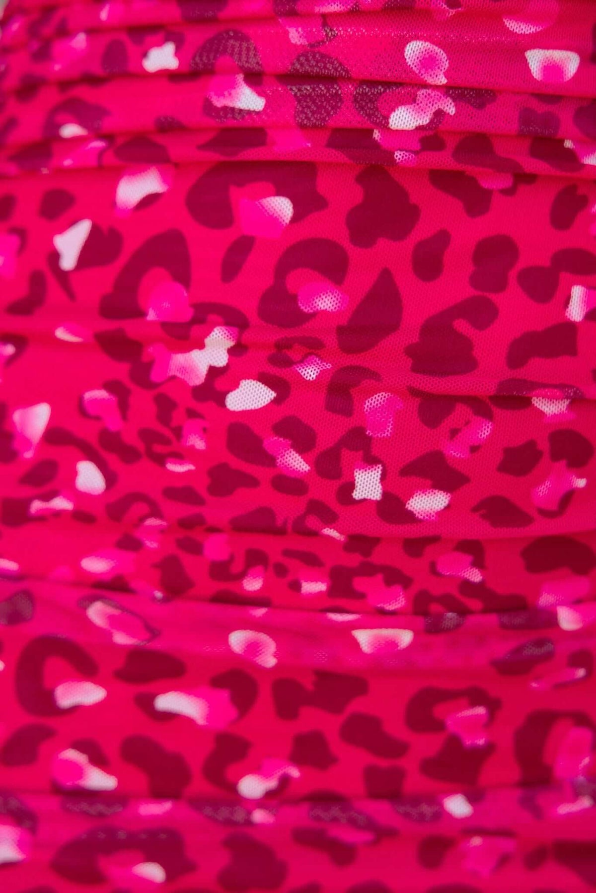 Close-up of pink leopard print fabric with ruffled texture, showcasing the stylish design of the Bailee Dress.