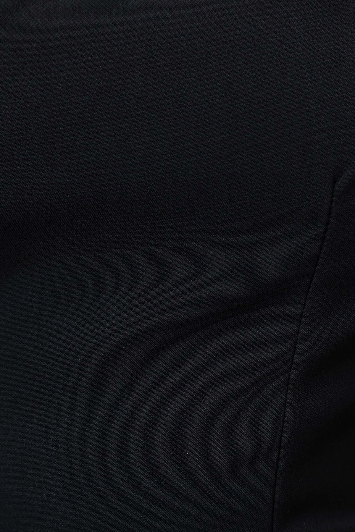 Close-up of the fabric texture of the Fallow Dress in black, highlighting its smooth and elegant finish.