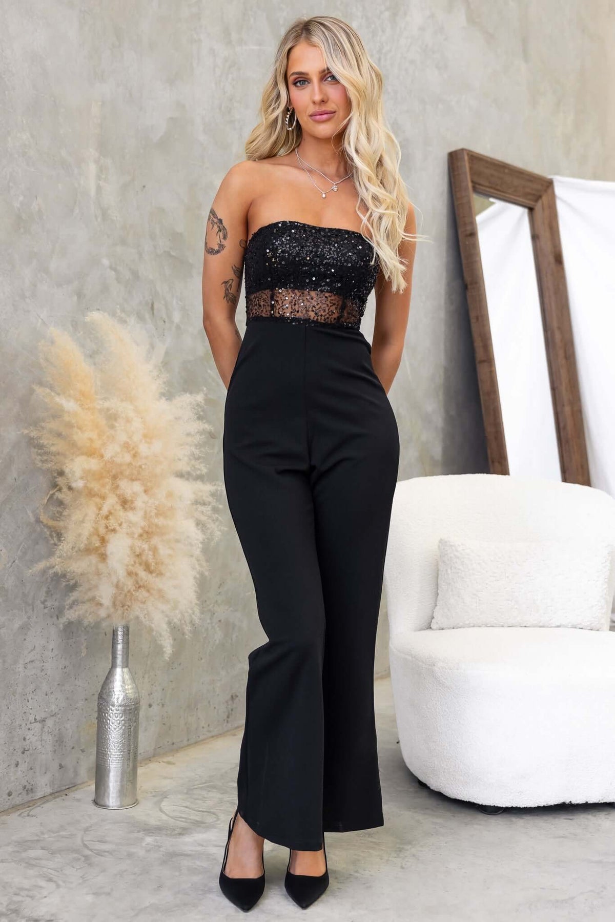 Black strapless Azura jumpsuit with sequins at the bust, featuring a fitted silhouette and anti-slip design.
