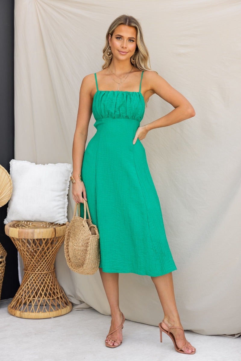 Stylish Leiko midi dress in vibrant green with adjustable tie straps and textured fabric, perfect for summer outings.