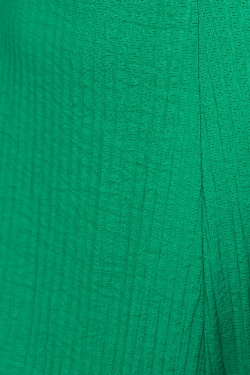 Close-up of textured green fabric from Leiko Midi Dress, showcasing its unique pattern and color.