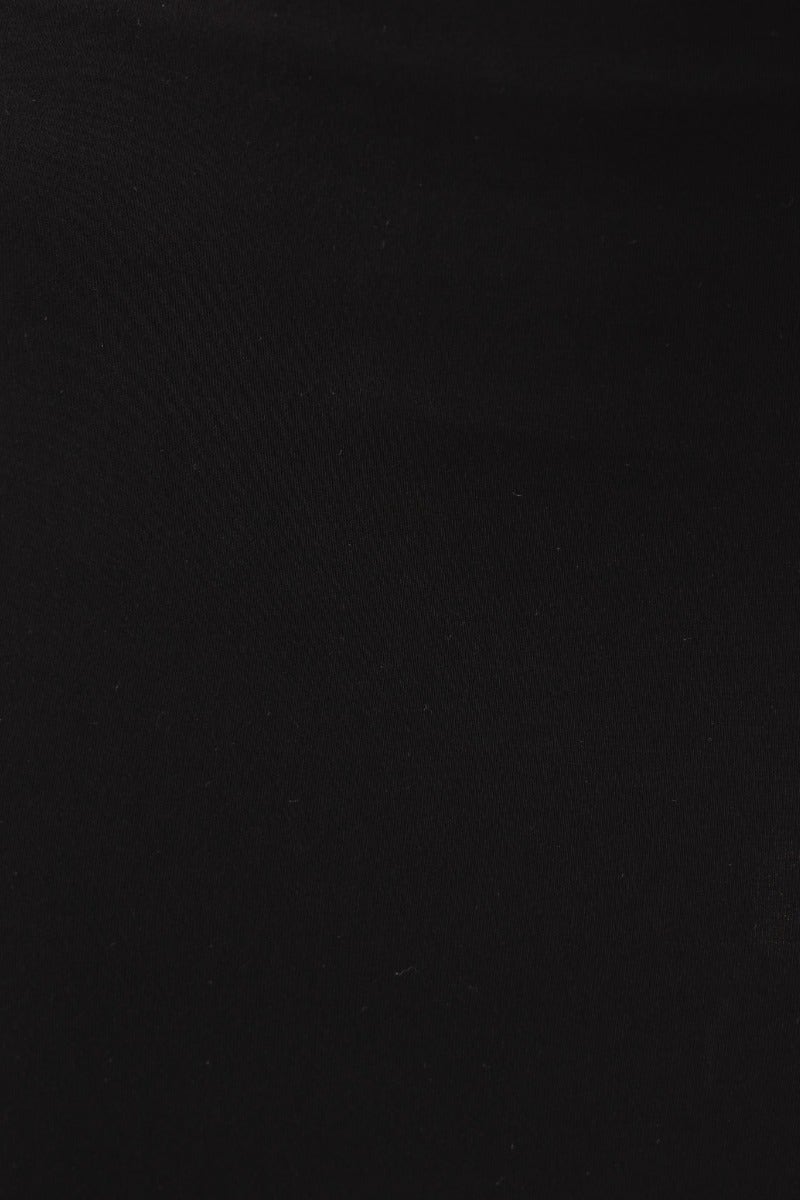 Close-up view of a black fabric, showcasing the texture of the Fearless Maxi Skirt, made from stretch cotton blend.