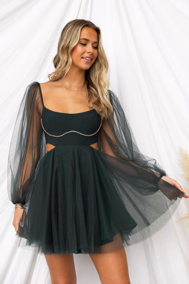 Dark green tulle Fiona dress with elastic sleeves, diamante detail, cut-out waist, and invisible zip, styled elegantly.