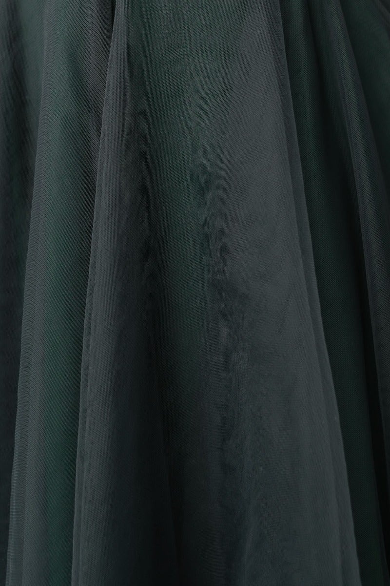 Dark green tulle fabric of the Fiona Dress, showcasing its elegant texture and layered design.