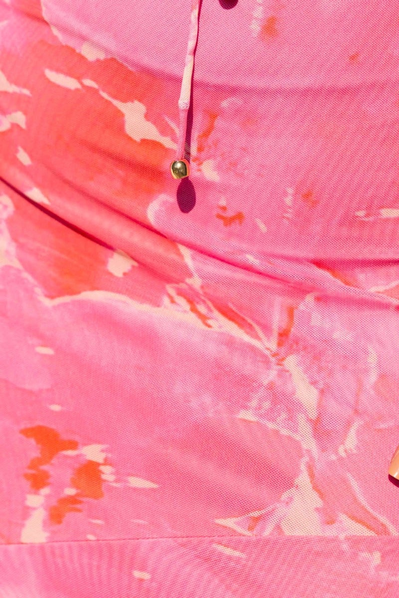 Close-up of the Pisces Maxi Dress featuring a vibrant multi-colour tie detail and artistic pink swirl pattern.