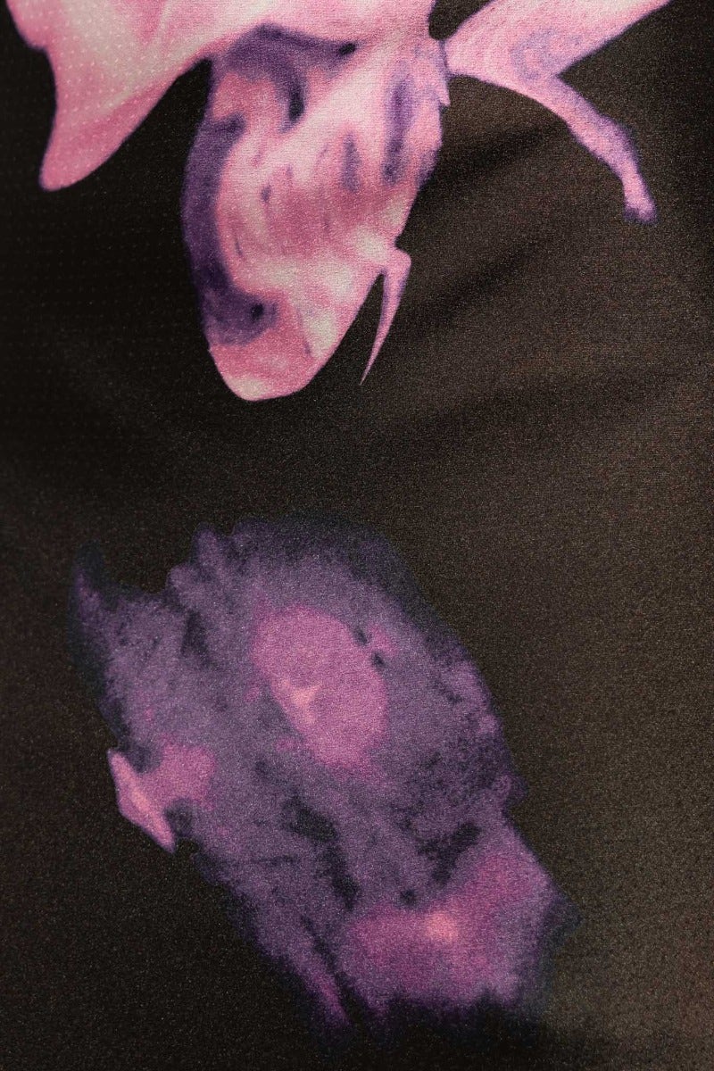 Close-up of floral print in shades of purple on a dark background, showcasing intricate design details of the Irisse Midi Dress.