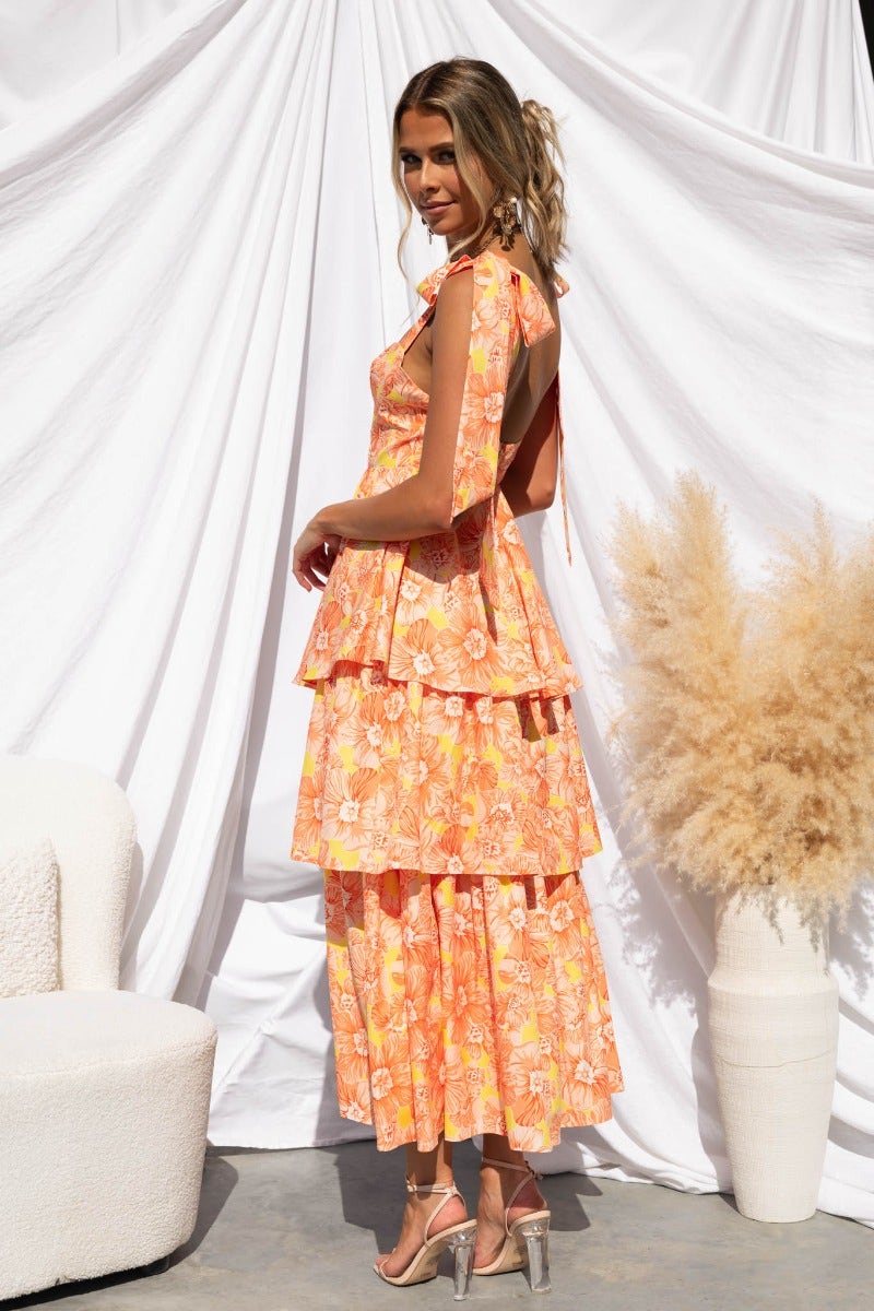 Model wearing Connali floral print maxi dress with tiered design and adjustable straps against a white backdrop.
