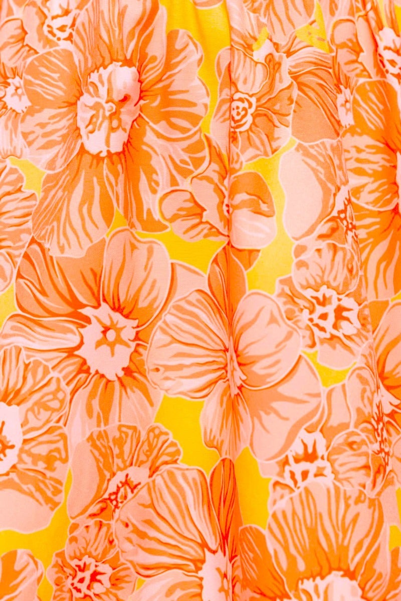 Close-up of vibrant floral print in orange and yellow tones on Connali Maxi Dress fabric.