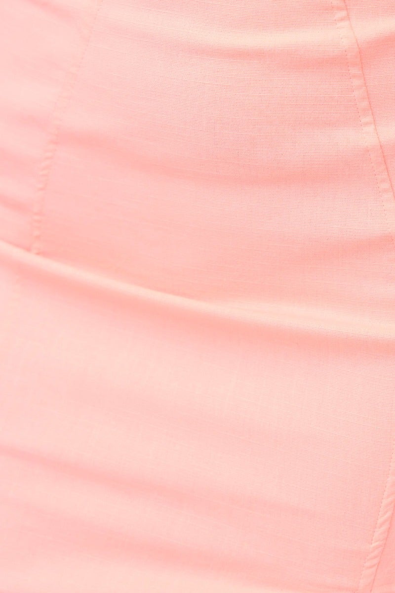 Close-up of soft pink fabric of a Shilah Denim Dress, showcasing the stretch material and smooth texture.