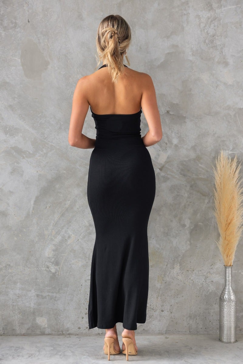 Black ribbed halter neck maxi dress, featuring a fitted silhouette and elegant styling, perfect for any occasion.
