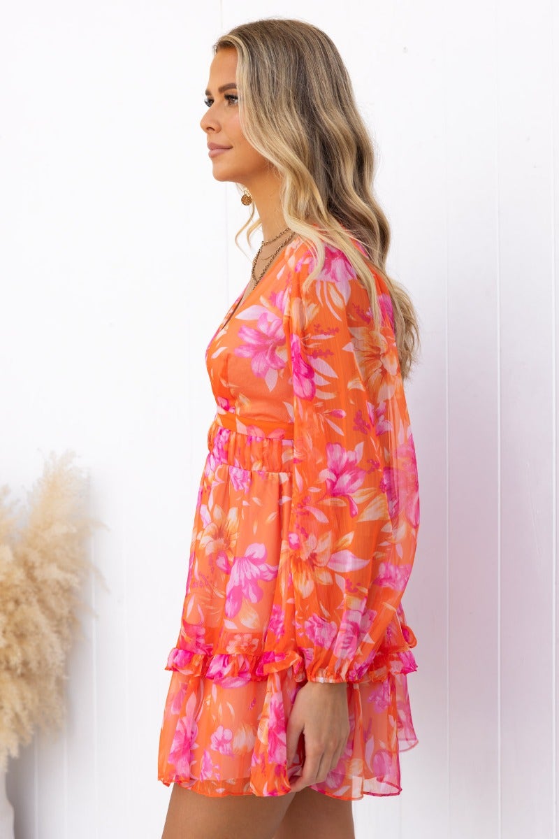 Floral print vanity dress in vibrant orange and pink, featuring a V-neckline and keyhole waist cut-out.