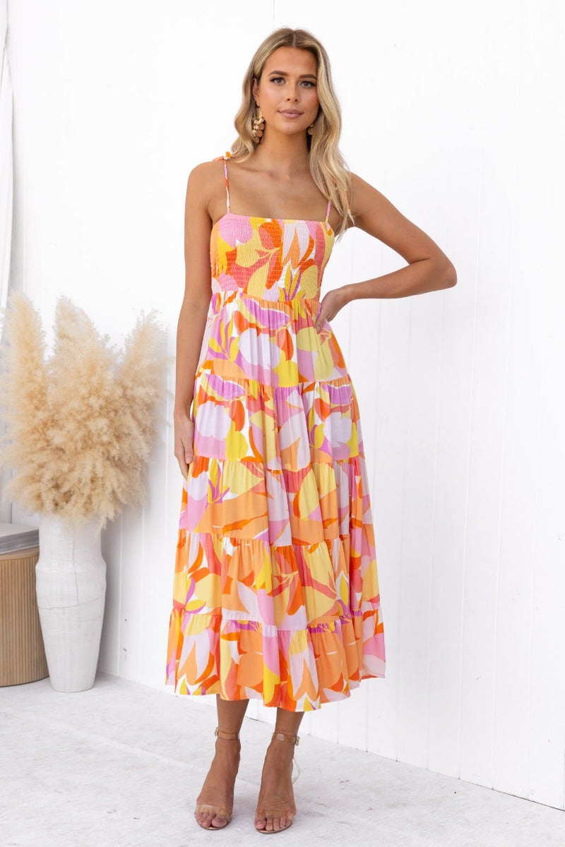 Model wearing the Island Cruise Midi Dress, a colorful, adjustable dress with a relaxed fit and elastic bodice.