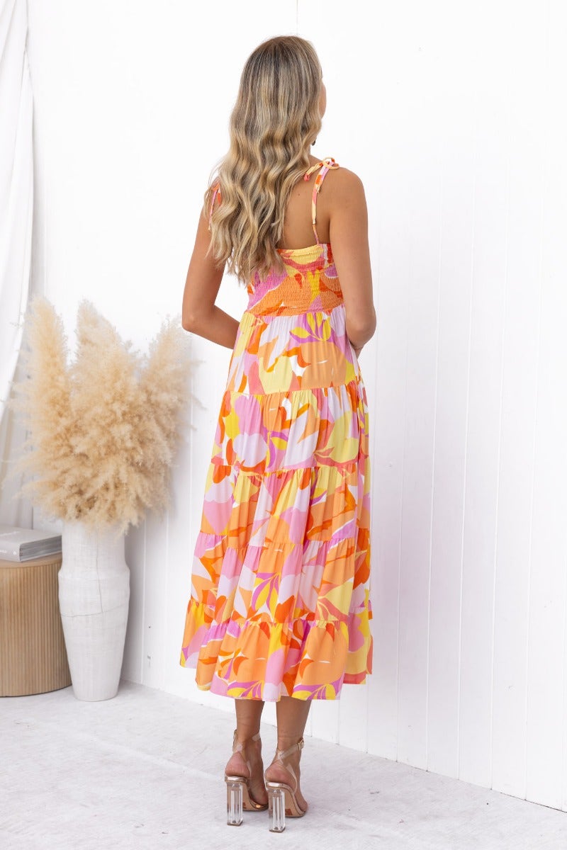 Back view of multi-colour Island Cruise Midi Dress with adjustable tie straps, showcasing a vibrant floral pattern.