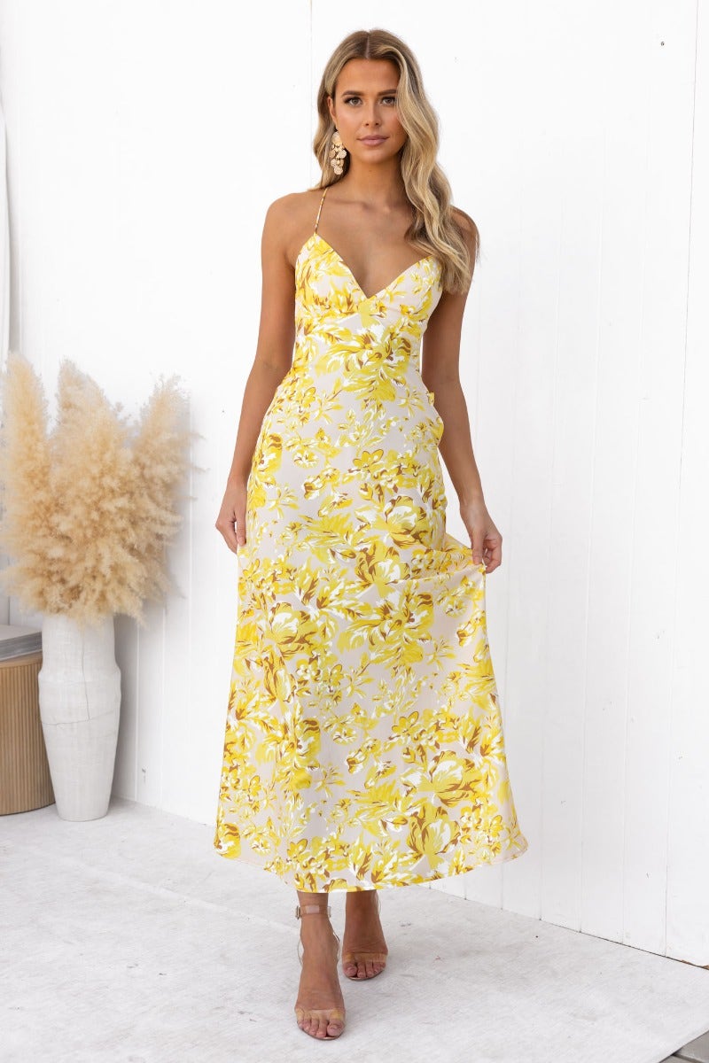 Floral print Ambra Maxi Dress featuring adjustable tie straps and draping material, perfect for summer occasions.