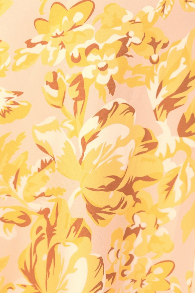 Floral print fabric featuring yellow and orange blossoms on a soft pink background, ideal for a stylish maxi dress.
